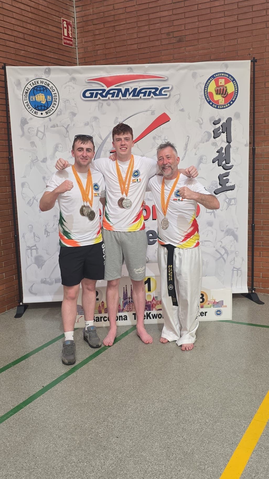 Three Blackrock Taekwon-Do competitors with their medals at the Catalunya Open in Barcelona