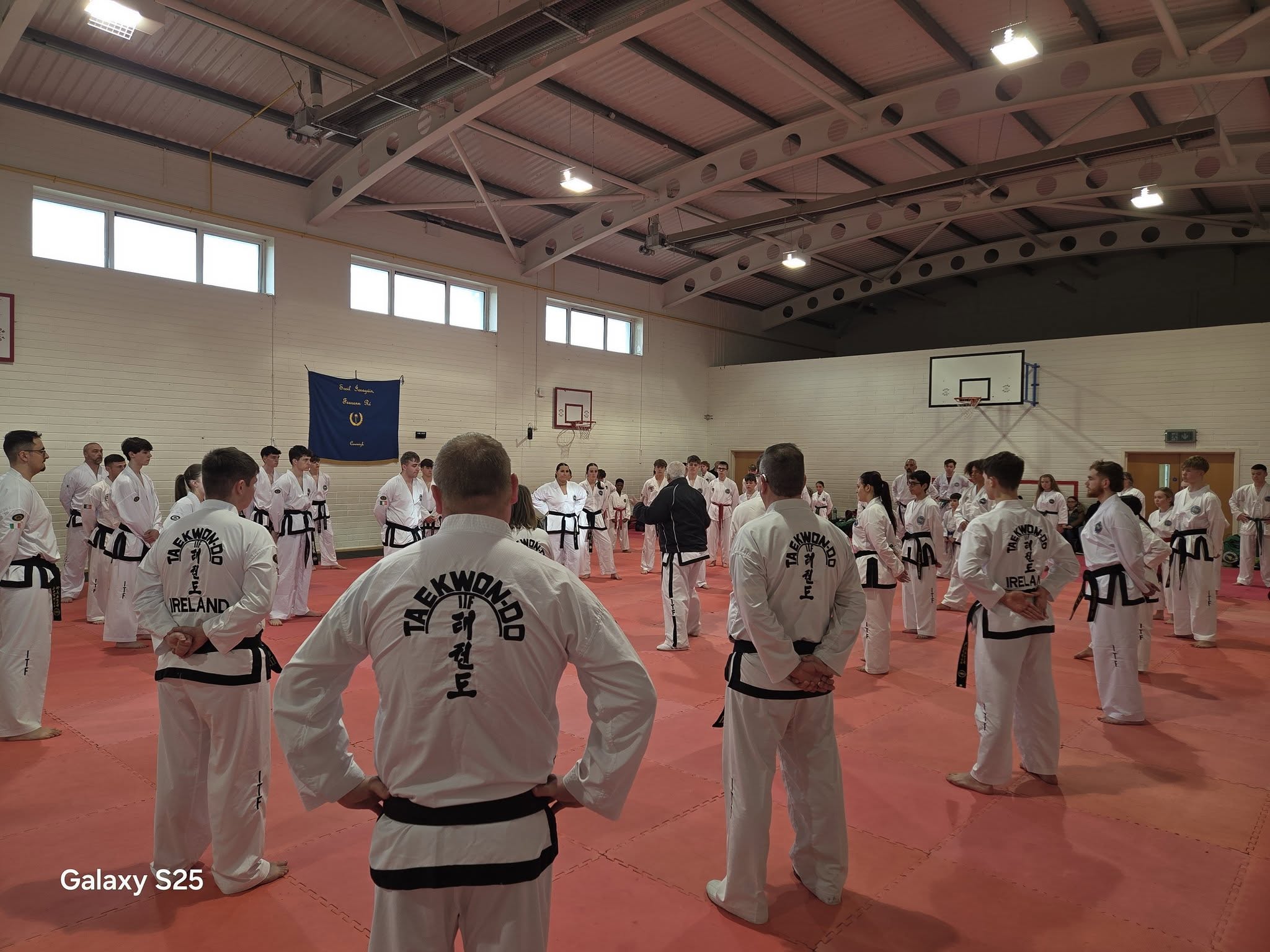 Full dojang of ITF Taekwon-Do students lined up in white doboks